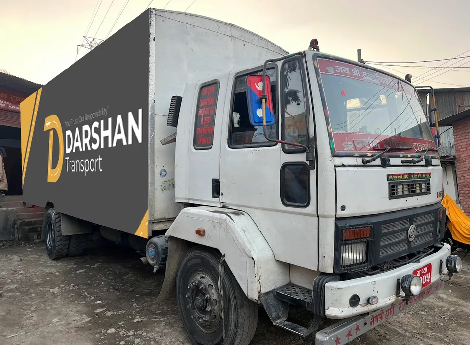 Branded Darshan Transport truck, front three-quarter view